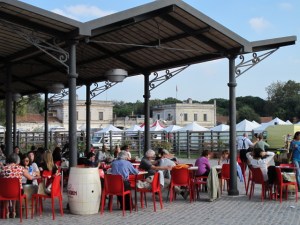 Outdoor seating. with vendor booths in the background