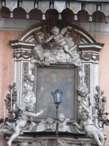 A shrine with a light, an elaborate frame, and a large canopy