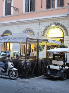 Enoteca Achilli has some outside seating, next to an electric car charging station.