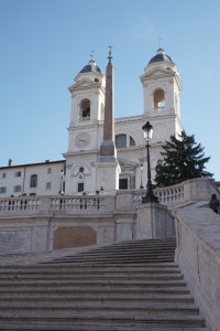 The church at the top of the Spanish Steps, behind the regal obelisk ...