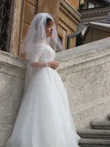 A sweetly smiling bride posing for a photo on the Spanish Steps, October 2016